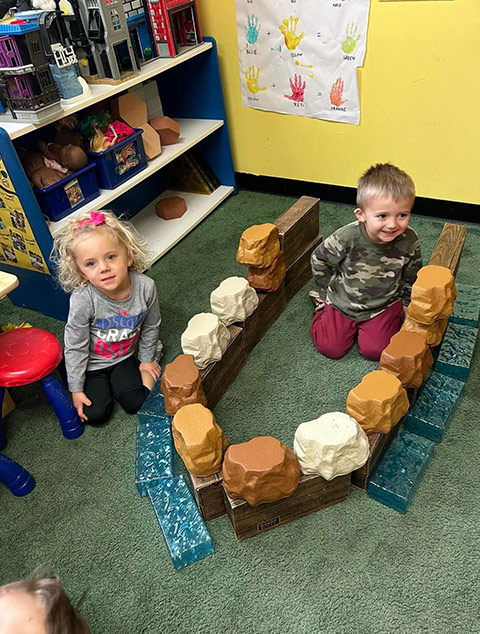 Pre-K Advanced - Kids playing with ice at Robins Nest Learning Center